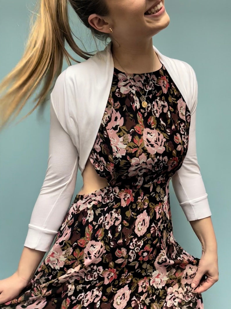 Bolero lightweight jacket, 3/4 sleeves, perfect over sleeveless dresses for arm coverage and shoulder  warmth. Colours come in black, white and navy, in sizes small, medium, large and Xlarge. Easily stored in a clutch bag, when not being worn.