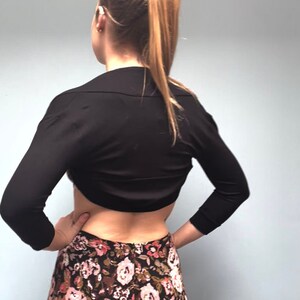 Bolero lightweight jacket, 3/4 sleeves, perfect over sleeveless dresses for arm coverage and shoulder  warmth. Colours come in black, white and navy, in sizes small, medium, large and Xlarge. Easily stored in a clutch bag, when not being worn.