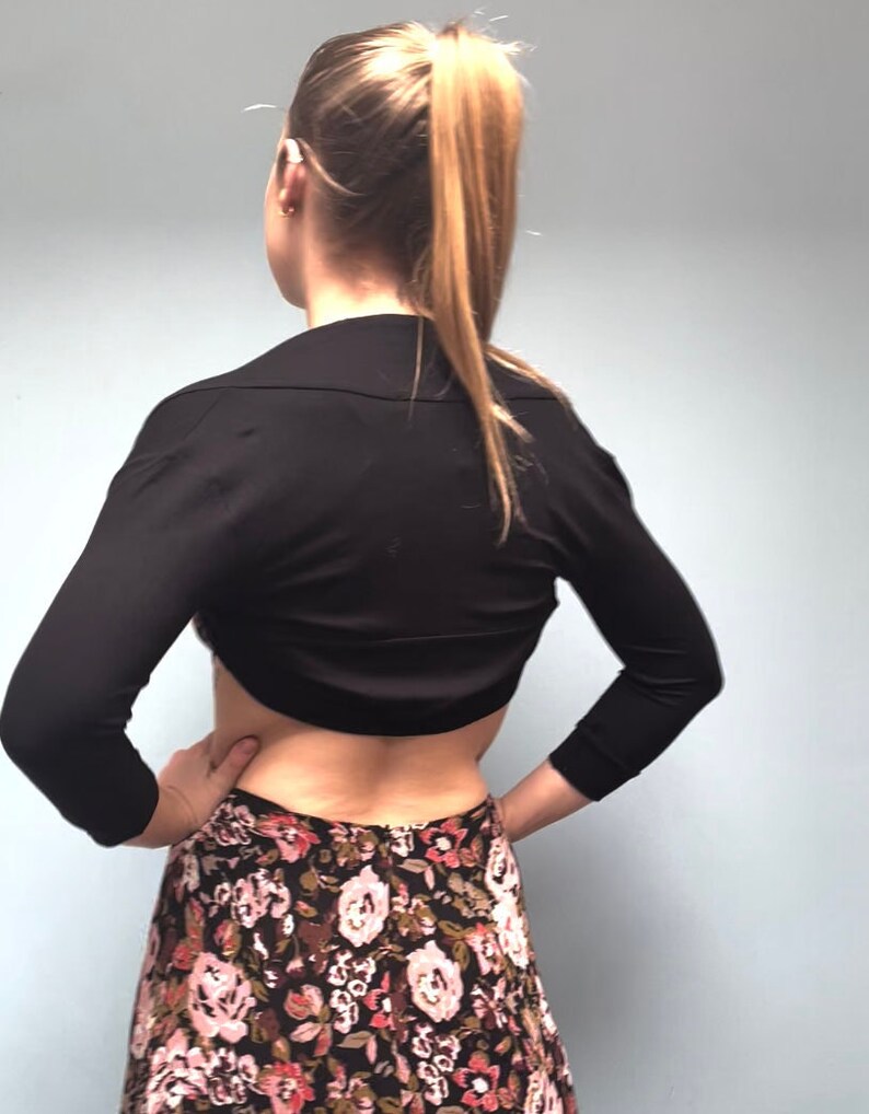 Bolero lightweight jacket, 3/4 sleeves, perfect over sleeveless dresses for arm coverage and shoulder  warmth. Colours come in black, white and navy, in sizes small, medium, large and Xlarge. Easily stored in a clutch bag, when not being worn.