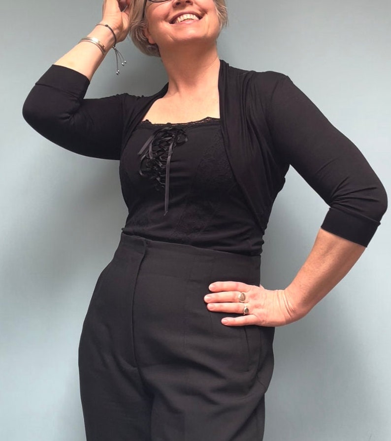 Bolero lightweight jacket, 3/4 sleeves, perfect over sleeveless dresses for arm coverage and shoulder  warmth. Colours come in black, white and navy, in sizes small, medium, large and Xlarge. Easily stored in a clutch bag, when not being worn.