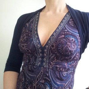 Bolero lightweight jacket, 3/4 sleeves, perfect over sleeveless dresses for arm coverage and shoulder  warmth. Colours come in black, white and navy, in sizes small, medium, large and Xlarge. Easily stored in a clutch bag, when not being worn.