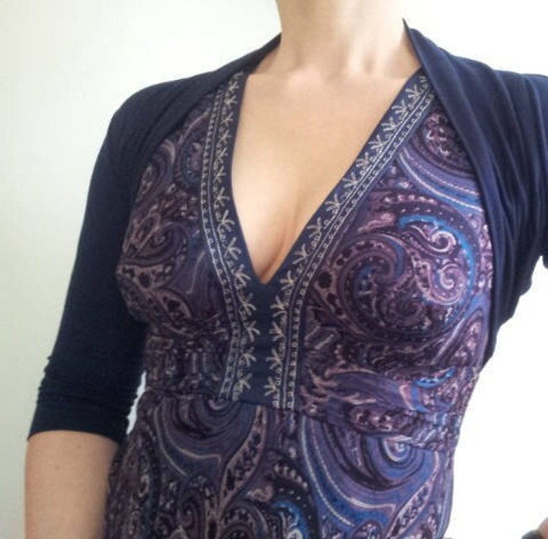 Bolero lightweight jacket, 3/4 sleeves, perfect over sleeveless dresses for arm coverage and shoulder  warmth. Colours come in black, white and navy, in sizes small, medium, large and Xlarge. Easily stored in a clutch bag, when not being worn.
