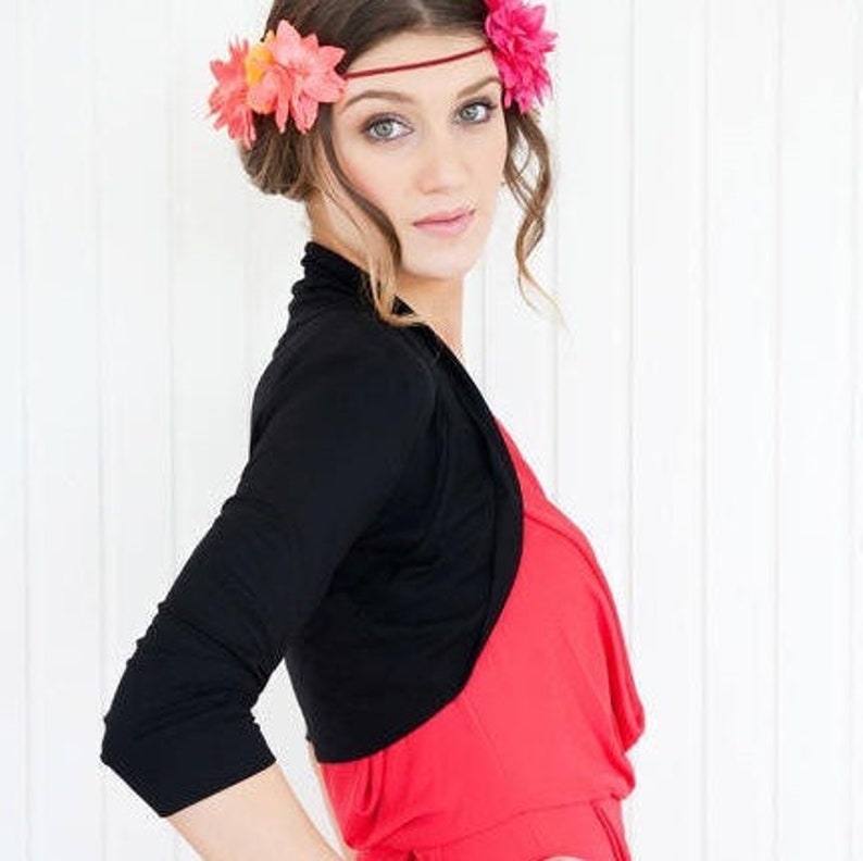 Bolero lightweight jacket, 3/4 sleeves, perfect over sleeveless dresses for arm coverage and shoulder  warmth. Colours come in black, white and navy, in sizes small, medium, large and Xlarge. Easily stored in a clutch bag, when not being worn.