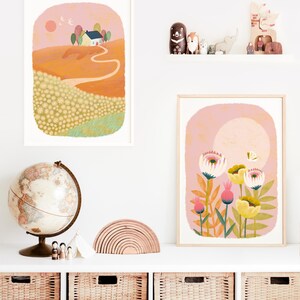 May include: Two framed illustrations, one depicting a yellow house on a hill with a winding path leading to it, and the other featuring a cluster of pink and yellow flowers with a butterfly.