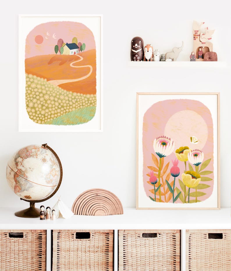 May include: Two framed illustrations, one depicting a yellow house on a hill with a winding path leading to it, and the other featuring a cluster of pink and yellow flowers with a butterfly.