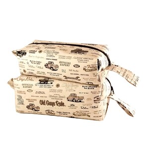 May include: Three stacked toiletry bags with a brown and white print featuring vintage cars, tools, and the text "Old Guys Rule".