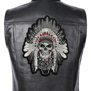 May include: Black leather vest with a large embroidered patch of a skull wearing a Native American headdress. The headdress is made of feathers and beads.