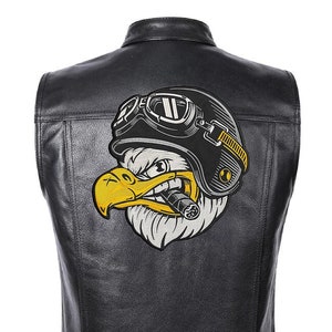 May include: Black leather motorcycle vest with a large embroidered patch of an eagle wearing a helmet and goggles, holding a cigar in its beak.