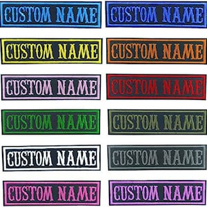 Può includere: Dieci toppe da stirare con il testo "CUSTOM NAME" in vari colori, tra cui blu, giallo, rosa, rosso, verde, bianco e grigio.