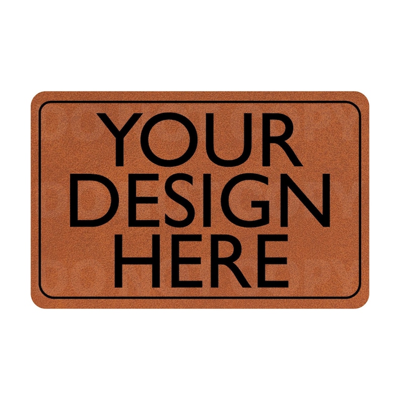 以下が含まれることがあります： 黒い文字で「YOUR DESIGN HERE」と印刷された茶色のドアマット