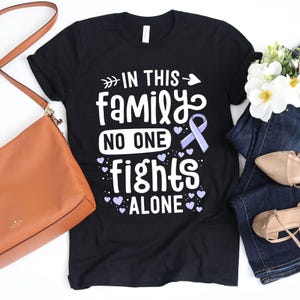 In This Family No One Fights Alone T-Shirt / Gastric Cancer / No One Fights Alone / In This Family / Periwinkle Ribbon / Stomach Cancer
