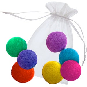 May include: Six colorful felt balls in a white organza bag. The balls are green, purple, blue, yellow, red, and pink.