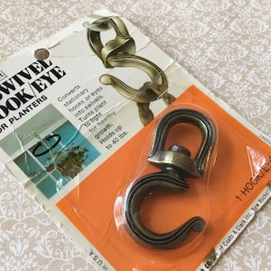 以下が含まれることがあります： オレンジと白のカードにパッケージされた、Homecraft #2 スイベルフック/アイプランター用。フックはブロンズ色で、固定フックをスイベルに変換するように設計されています。 最大18kgまで保持します。