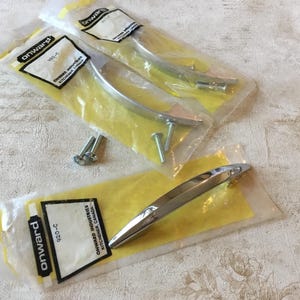 May include: Three packages of chrome cabinet hardware with the brand name "Onward" printed on the packaging. The hardware is packaged with screws.