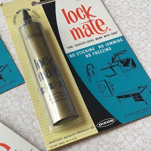 May include: Vintage Lock Mate graphite lubricant in packaging. The product is in a clear plastic blister pack with a yellow backing card. The packaging includes the text "ONE SQUEEZE-LOCKS WORK WITH EASE" and "NO STICKING NO JAMMING NO FREEZING."