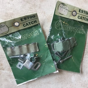 May include: Two packs of Amerock E9700 Catch hardware. Each pack contains a metal catch, screws, and a green fabric strip. The packs are labelled with the product name and number, and the price of 25 pence.
