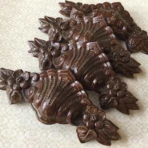 May include: A white ceramic mug with a black handle and the text "But First, Coffee" in a black, handwritten-style font. The mug is on a white surface.