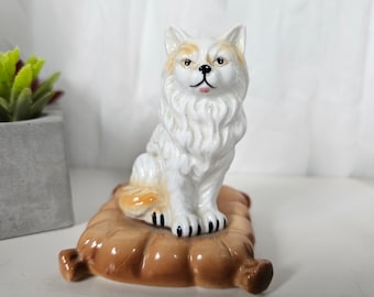 Vintage cat figurine on cushion
