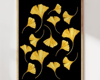May include: A framed art print featuring a black background with scattered golden ginkgo leaves. The leaves have detailed veining and a textured appearance. The artwork is displayed in a wooden frame, suitable for home decor.