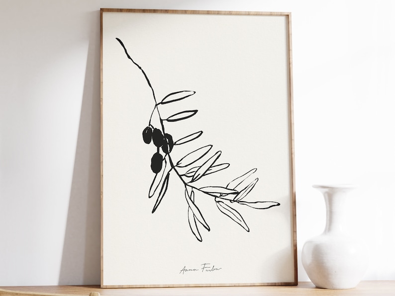 May include: Black and white line art print of an olive branch with olives. The print is signed "Anna Fidler" in the bottom right corner.