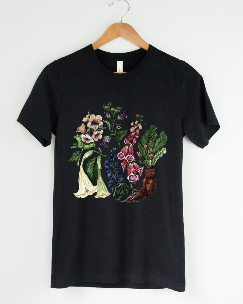May include: Black t-shirt with a floral print featuring various flowers in shades of pink, purple, white, and green.