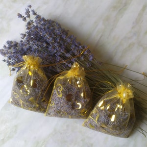 Three fragrant lavender sachets. The smell of lavender relieves stress. Bed linen freshener. Great for cabinets, drawers, cars.From moths.
