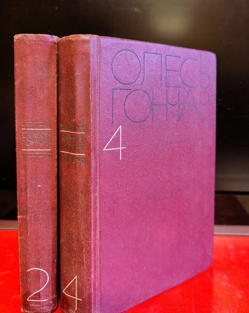 Puede incluir: Dos libros de tapa dura color burdeos con el t&iacute;tulo "Олег Гончар" y el n&uacute;mero "4" en la portada. El libro de la izquierda tiene el n&uacute;mero "2" en el lomo y el libro de la derecha tiene el n&uacute;mero "4" en el lomo.