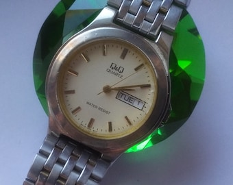 Vintage men's watch Q&Q. Men's quartz wrist watch in silver color with a metal bracelet.