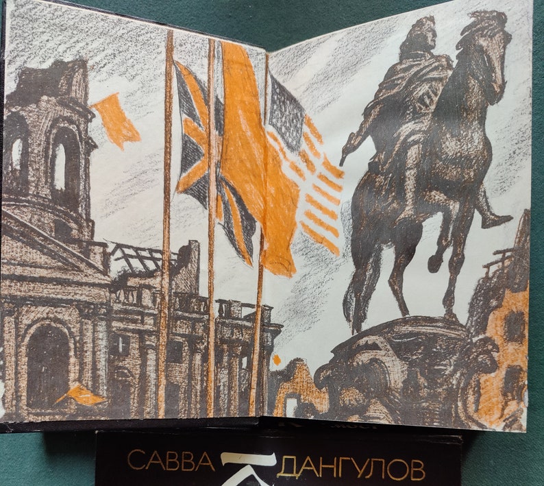 May include: An open book with a pencil drawing of a city scene with a statue of a person on horseback. The city scene includes buildings, flags, and a sky. The book is open to a page with the text 'Савва Дангулов' at the bottom of the page.