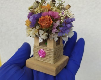 Mini-bouquet of dried flowers. A small bouquet in a ball of wire on an ash stand. Mini souvenir made of dried flowers. N5