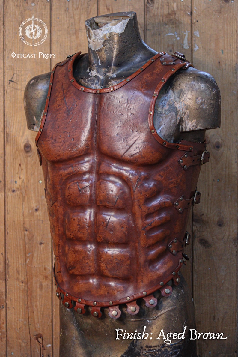 Front view of a Roman leather musculata cuirass, handcrafted with brown aged leather and metallic rivets. The armor features sculpted abdominal muscles and distressed textures for a realistic battle-worn look. Ideal for Roman gladiator cosplay, LARP armor, or historical reenactment costume. Made from eco-tanned full-grain leather with epic weathering techniques.