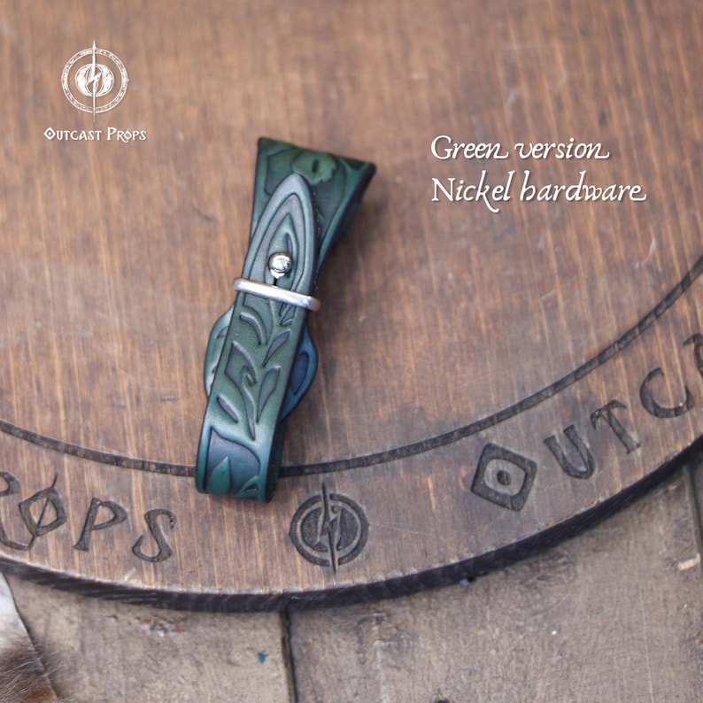 May include: A green leather strap with nickel hardware. The strap features an embossed floral design and a silver-colored metal ring. The text "Green version Nickel hardware" is visible in the image.