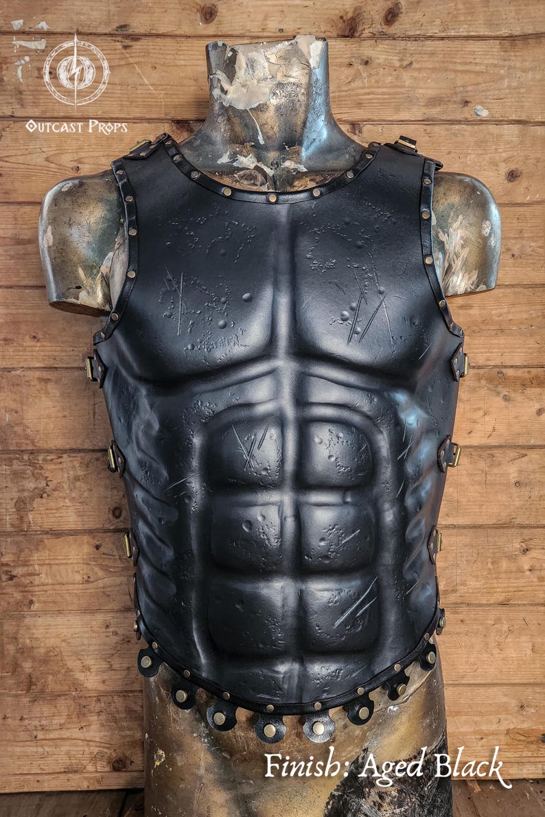 Front view of Roman leather musculata armor with visible abdominal definition, black leather surface and studded hemline. Ideal for Spartacus cosplay, Roman general costumes and medieval LARP. The muscle shaping and textured finish aid accessibility for low-vision users. Crafted with vegetable-tanned leather and hand-aged for a realistic, battle-worn look straight from history.