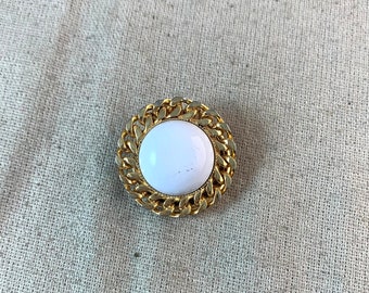 Vintage Dress Clip, 1 1/8" in diameter, white acrylic cabochon center, gold tone base metal, unbranded