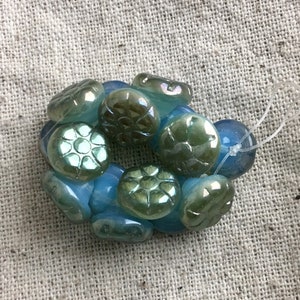 Czech Pressed Glass Buttons, green with blue, luster finish, 10 mm, 1 mm hole, 15 buttons per strand