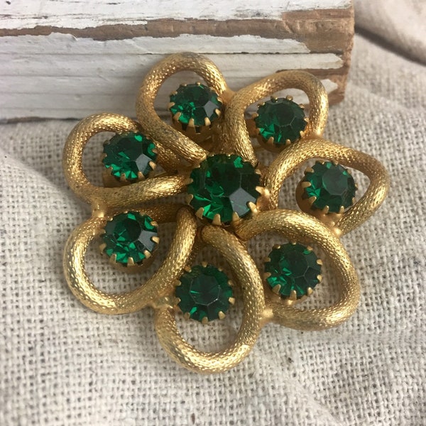 Vintage Rhinestone Brooch, textured gold tone base metal, green prong set rhinestones, unsigned