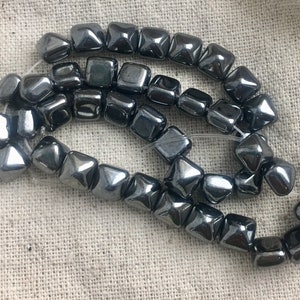 Czech Glass Stud Beads in Hematite Finish, 7 mm x 6 mm, double drilled with 1 mm holes, 20 beads per strand
