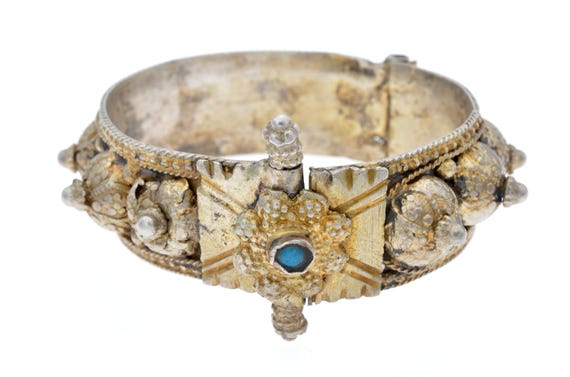 Old tribal bracelet from Sumatra. Antique bracelet in golden silver from Indonesia