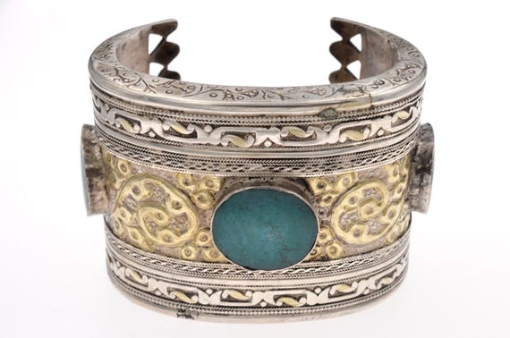 Open high grade silver cuff adorned with antique Kazakh floral motifs and set with three turquoise cabochons