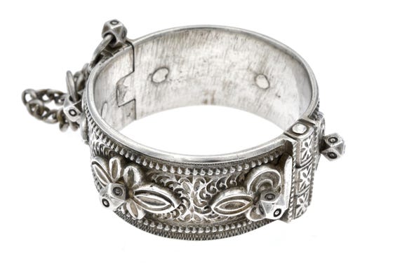 Antique Moroccan silver hinged bracelet, old tribal ethnic cuff with applied floral ornaments and safety chains
