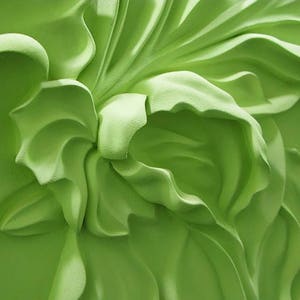 May include: A close-up of a green, 3D floral wall decor with a textured, sculpted design.