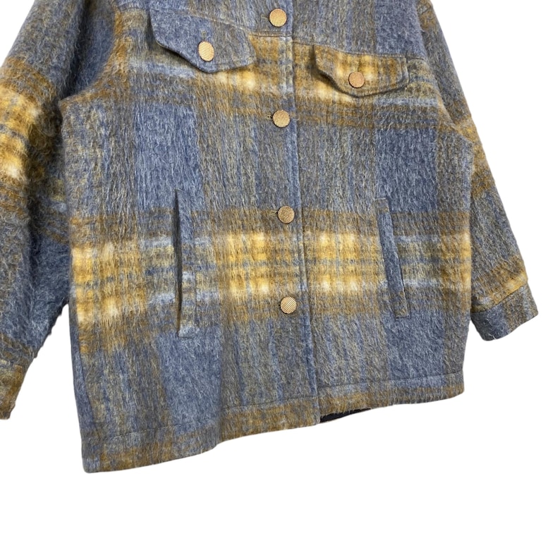 May include: A blue and yellow plaid jacket with a button-up front, two chest pockets, and two side pockets. The jacket has gold-colored buttons and a soft, textured appearance. The plaid pattern is a mix of blue and yellow.