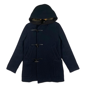 May include: A navy blue duffel coat with a hood and toggle closures. The coat has two front pockets and a dark lining visible at the hood's opening. The coat is made of a thick, warm material, perfect for cold weather.