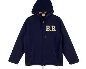May include: A navy blue fleece zip-up hoodie with a large white embroidered "B.B." logo on the front.