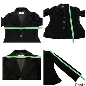 May include: Black blazer with a notched collar, long sleeves, and a button closure. The blazer has a fitted silhouette and a slightly flared hem.