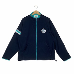 May include: A navy blue zip-up jacket with a teal zipper and trim. The jacket has a white and teal stripe on the sleeve and a circular logo with the text "Seattle Mariners" on the chest.