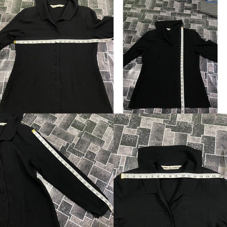 Puede incluir: Camisa negra de manga larga con botones y cuello. La camisa tiene una silueta ajustada y est&aacute; hecha de una tela lisa. La camisa se mide con una cinta m&eacute;trica.