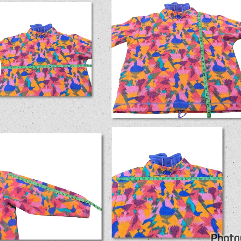 May include: A multi-colored fleece pullover with a geometric pattern of pink, orange, blue, green, and yellow. The fleece has a high neck and a drawstring at the bottom.
