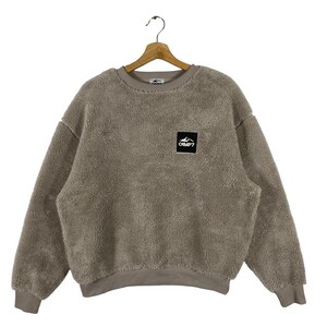 May include: A brown fleece sweatshirt with a small black patch logo that says "CAMP7" on the front.
