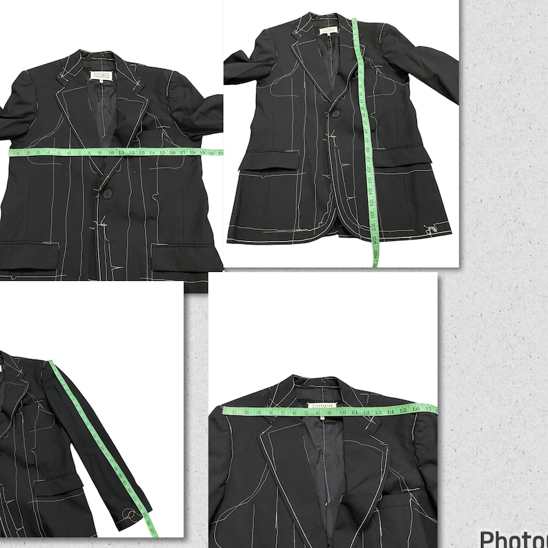 May include: A black blazer with white stitching detail. The blazer has two pockets and a single button closure. The blazer is laid flat on a white surface.